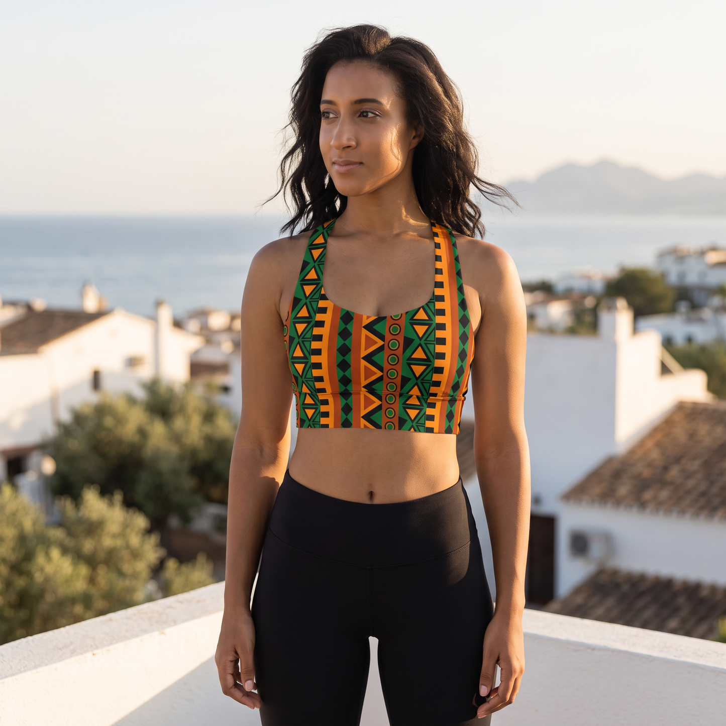 Woman wearing the Mzansi Recycled Longline Sports Bra on a rooftop terrace