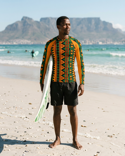 Man holding a surfboard on the beach in the Mzansi Men's Rash Guard