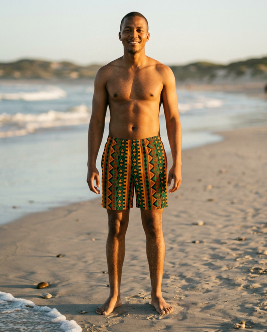 Man on the beach at golden hour wearing Mzansi Recycled Swim Trunks